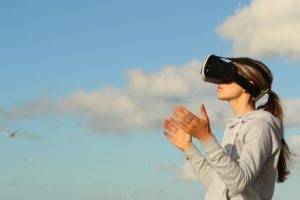 woman wearing virtual reality goggles outside